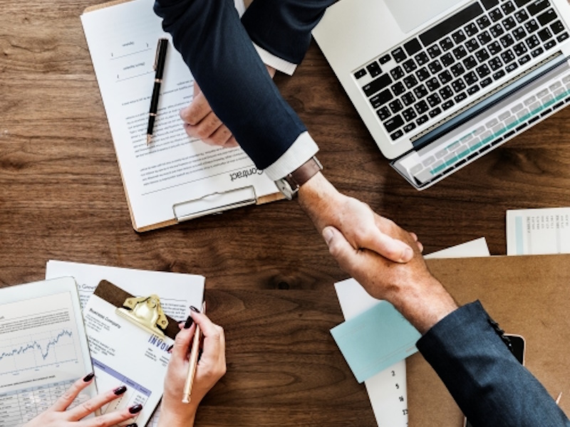 businesspeople shaking hands together